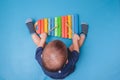 Bird eye view of Cute little Asian 18 months / 1 year old baby boy child hold sticks & plays a musical instrument colorful wooden Royalty Free Stock Photo