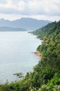 Bird eye view of tropical landscape with stone coastline, coconut palm trees, tropical sea and mountains on Koh Chang island Royalty Free Stock Photo