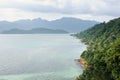 Bird eye view of tropical landscape with stone coastline, coconut palm trees, tropical sea and mountains on Koh Chang island Royalty Free Stock Photo