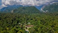 Bird-eye view of village Mulu surrounded by forest and mountains near Gunung Mulu national park. Borneo. Sarawak. Royalty Free Stock Photo