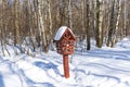 Bird feeder box in the snow covered forest Royalty Free Stock Photo