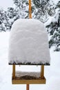A bird feeder covered with a high layer of freshly fallen snow Royalty Free Stock Photo