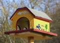 Bird feeder with painting showing a rural scene, horizontal