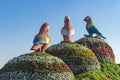 Bird figures standing on bushes under the sunlight in the Dubai Miracle Garden in UAE