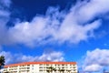 A bird flies in the blue sky among the clouds Royalty Free Stock Photo