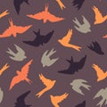 Seamless pattern with migrating birds. Colored birds on a purple background. Surface design. Royalty Free Stock Photo