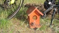 Bird house. Sparrow`s house on land on a bike standing in the park background. Bird house, Birdhouse Sparrow`s house on land in th