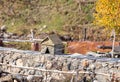 A bird  house stands on a stone fence in Ushguli village on a background of mountains in Svaneti in the mountainous part of Royalty Free Stock Photo