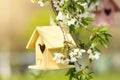 Bird houses hanging outdoors, focus on yellow one