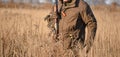 Bird Hunter Silhouetted at Sunrise with dead bird on his hand Royalty Free Stock Photo