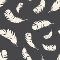 Bird light feathers fly on a dark background. Seamless pattern