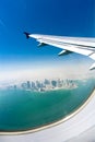 Bird's eye view on the city under the plane wing Royalty Free Stock Photo