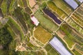 Bird\'s eye view of colorful, terraced agricultural land with flower fields and greenhouses on a mountain slope. At Northern Royalty Free Stock Photo