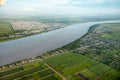 Bird`s-eye view of the Demerara River, rural houses, rectangular green fields taken from an airplane, South America. Rivers Royalty Free Stock Photo