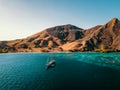 Bird`s Eye View of an Dive Boat in front of Komodo Island with visible Reef, Indonesia. Liveaboard Drone Shot.