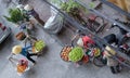 A bird\'s-eye view of a fruit seller and a variety of products that Vietnamese people carry along the streets of Hanoi