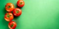 top view of a kitchen worktop with juicy large tomatoes on the left side of the picture