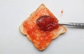 strawberry jam, fresh red berries in a spoon spread slice of bread isolate on a white backdrop