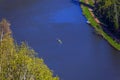 Bird's eye view of a river with people in a canoe Royalty Free Stock Photo