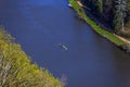 Bird's eye view of a river with people in a canoe Royalty Free Stock Photo