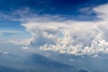 The bird's eye view on the sky with the huge fluffy dramatic clouds above the Alps Royalty Free Stock Photo