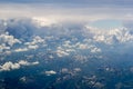 The bird's eye view on the sky with the huge fluffy dramatic clouds above the Alps Royalty Free Stock Photo