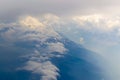 The bird's eye view on the sky with the huge fluffy dramatic clouds above the Alps Royalty Free Stock Photo