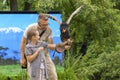 Bird show with Bateleur Eagle. Predatory bird from Africa. A little girl in leather glove takes an eagle. Leisure for a family