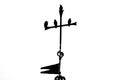 Bird silhouette on top of an iron cross