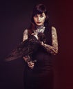 Bird, tattoo or portrait of woman in studio for fashion or edgy style isolated on black background. Pied crow, dark or Royalty Free Stock Photo