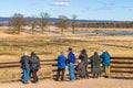 Bird watcher watching cranes at lake horborgasjon in Sweden