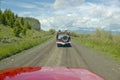 Bird watchers and red jeep in spring grasslands and mountains in Centennial Valley, Lakeview MT