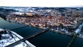 Bird's eye view of a city next to a riverbed during the winter