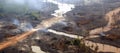 Bird's-eye view of lifeless water-flooded land of cut down and burnt rainforest. Banner.