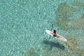 Bird& x27;s Eye View of Paddleboarder on a Shimmering Sea Royalty Free Stock Photo