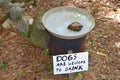 Birdbath with humorous sign