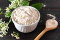 Birdcherry flour in a bowl on dark wooden background