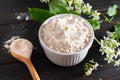 Birdcherry flour in a bowl on dark wooden background