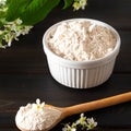 Birdcherry flour in a bowl on dark wooden background