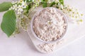 Birdcherry flour in a bowl, top view on grey background