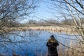 Birder by a pond in spring season