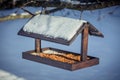Wooden Birdfeeder on a tree in winter Royalty Free Stock Photo