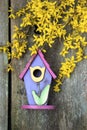 Birdhouse on old wooden fence