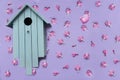 Birdhouse and pink bird and flowers a lilac background. Royalty Free Stock Photo