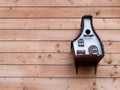 Birdhouse or roost box on the wooden wall of a building, selective focus. Care for animals Royalty Free Stock Photo