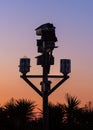 Birdhouses against a sunrise sky