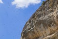 Birds in the blue sky over the rocks Royalty Free Stock Photo