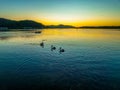 Birds, boat and fishermen, sunrise at the waterfront