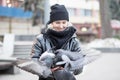 Birds doves eat sunflower seeds from the hands of a beautiful young girl in a black jacket Royalty Free Stock Photo