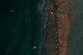 Birds eye aerial view of some seagulls standing on a beach and flying over the sea Royalty Free Stock Photo